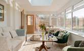 This stunning conservatory is the perfect place to drink in the rural landscape beyond. Lots of comfy seating, a dining space and even a bed for your four-legged friend. - Thumbnail Image