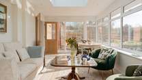 This stunning conservatory is the perfect place to drink in the rural landscape beyond. Lots of comfy seating, a dining space and even a bed for your four-legged friend.