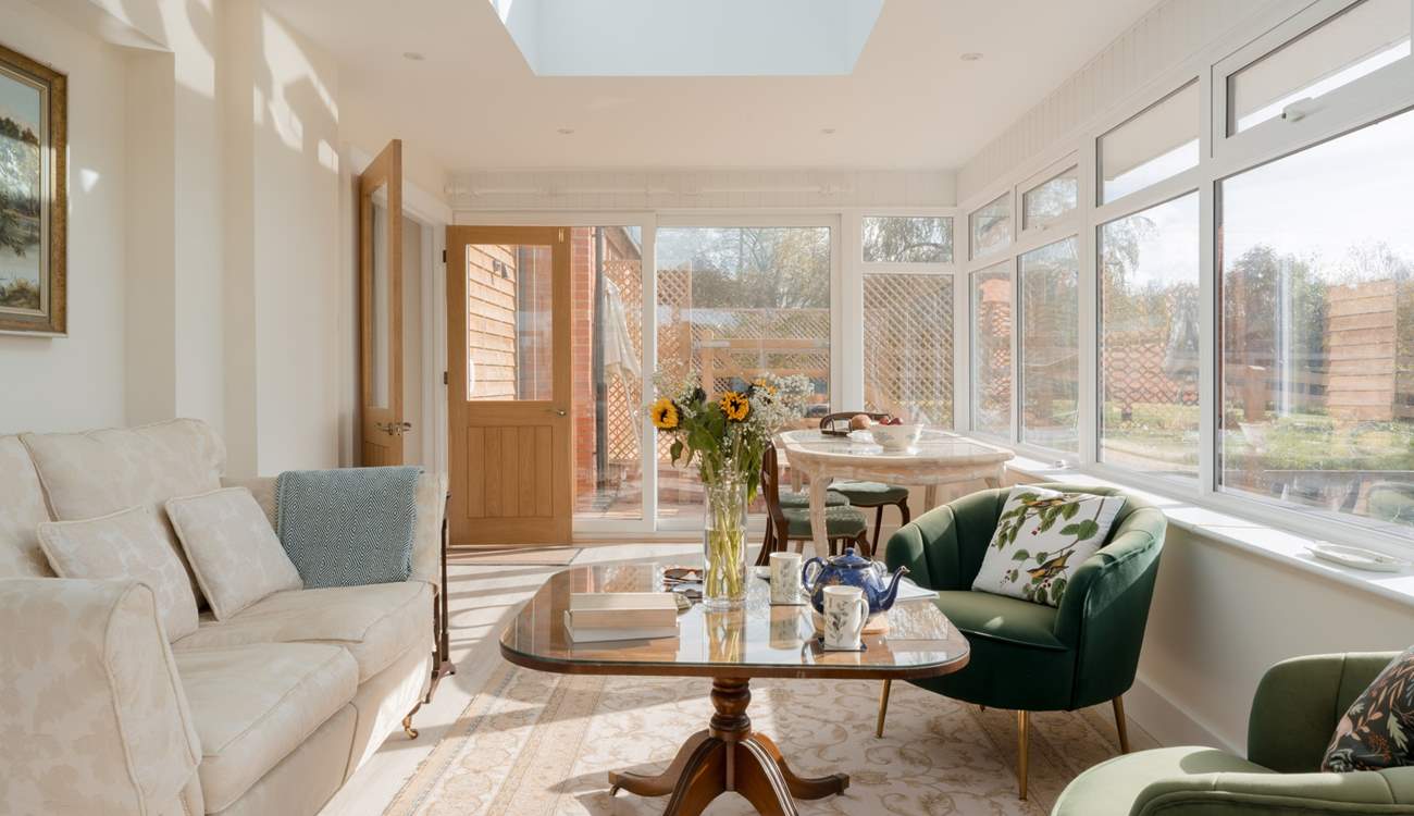 This stunning conservatory is the perfect place to drink in the rural landscape beyond. Lots of comfy seating, a dining space and even a bed for your four-legged friend.