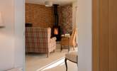 The wood-burner and exposed brickwork make for a really rustic and cosy experience. - Thumbnail Image