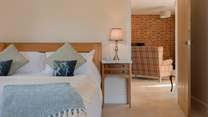 The large luxury bedroom leads seamlessly to the main living space.