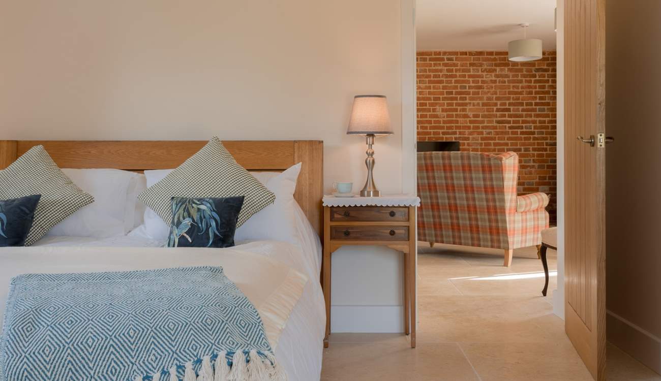 The large luxury bedroom leads seamlessly to the main living space.