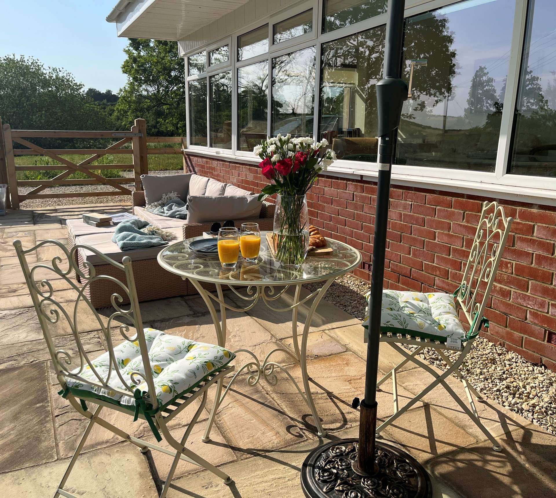 A bistro table for two and a comfy outdoor sofa, all surrounded by the sounds of nature.