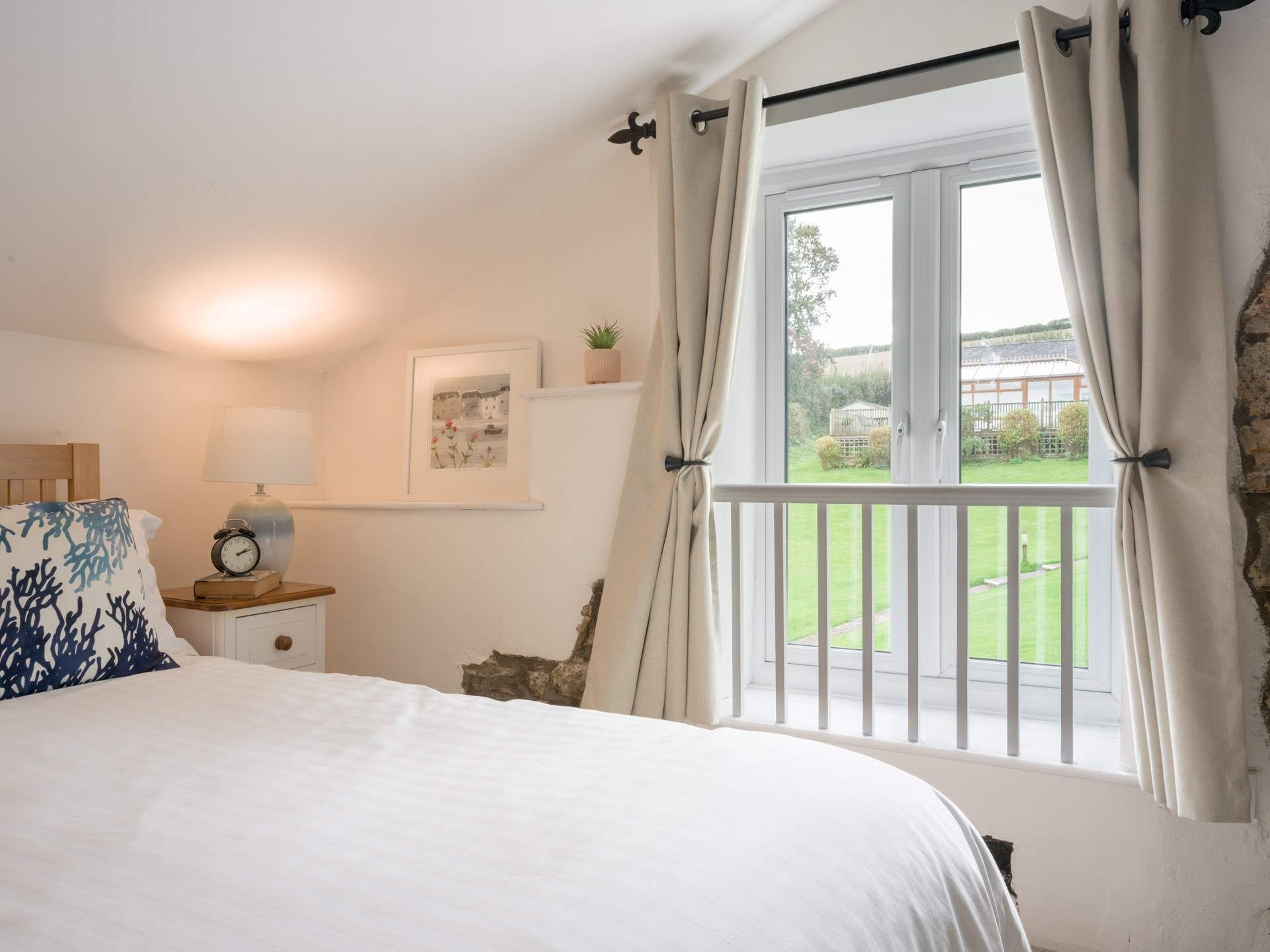 Bedroom 2 has views out to the communal area and swimming pool building.
