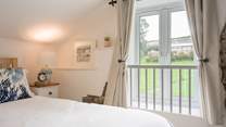 Bedroom 2 has views out to the communal area and swimming pool building.
