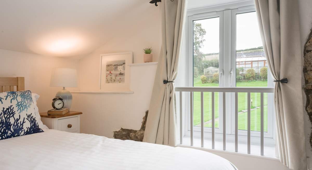 Bedroom 2 has views out to the communal area and swimming pool building.