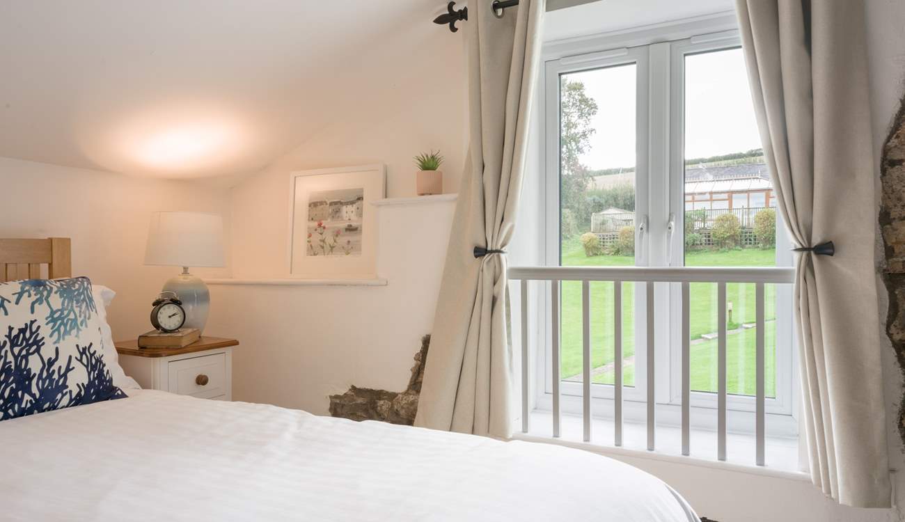 Bedroom 2 has views out to the communal area and swimming pool building.