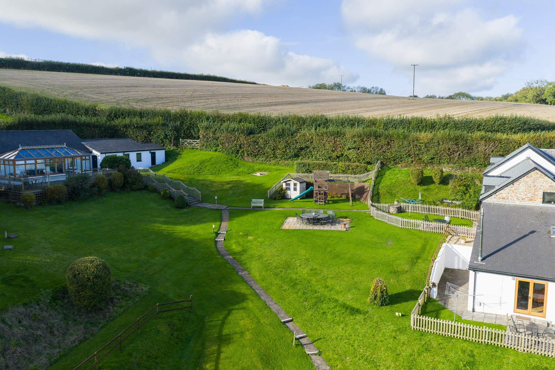 Head out of the gate and follow the path to the swimming pool and games-room.