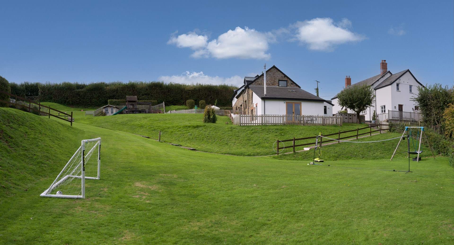 Looking up to Wren Cottage from the children's play area.