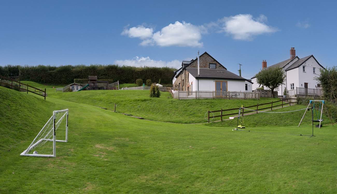 Looking up to Wren Cottage from the children's play area.
