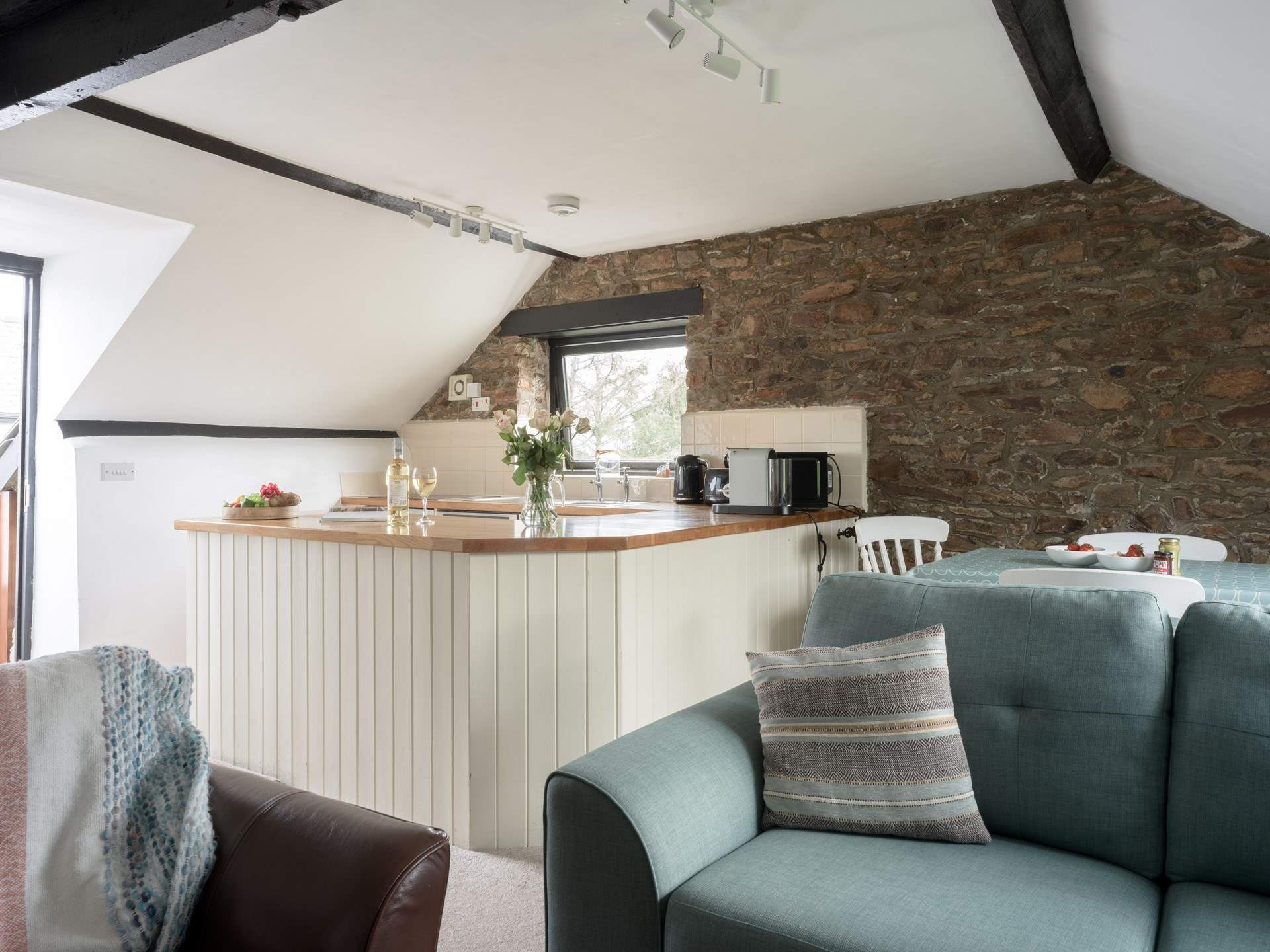 The sociable open plan living area is lovely and light with two sofas.