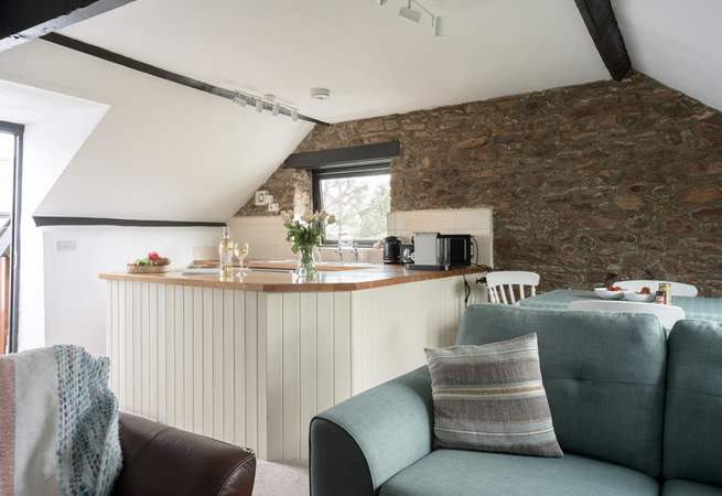 The sociable open plan living area is lovely and light with two sofas.