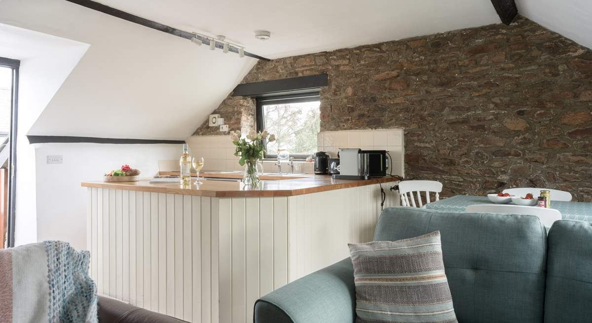 The sociable open plan living area is lovely and light with two sofas.