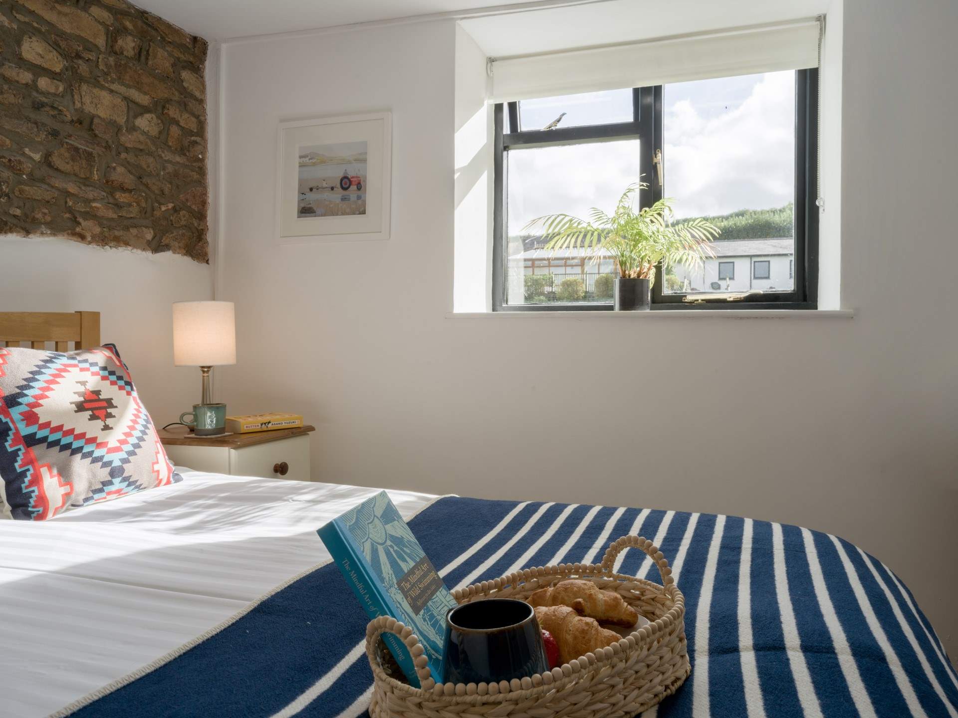 The bedroom looks out over the communal grounds towards the swimming pool.