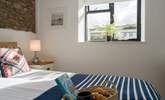 The bedroom looks out over the communal grounds towards the swimming pool. - Thumbnail Image