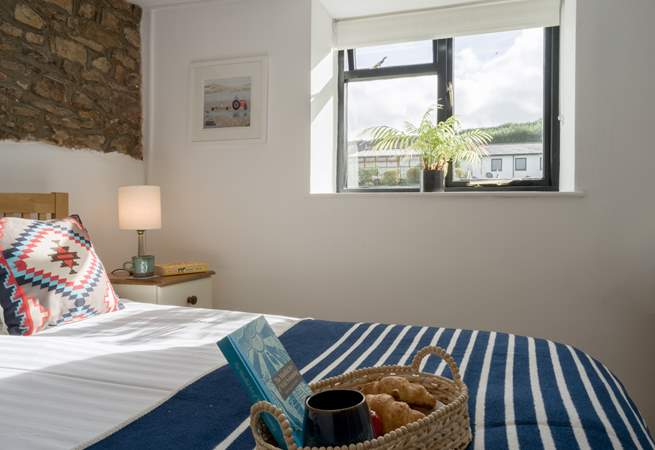 The bedroom looks out over the communal grounds towards the swimming pool.