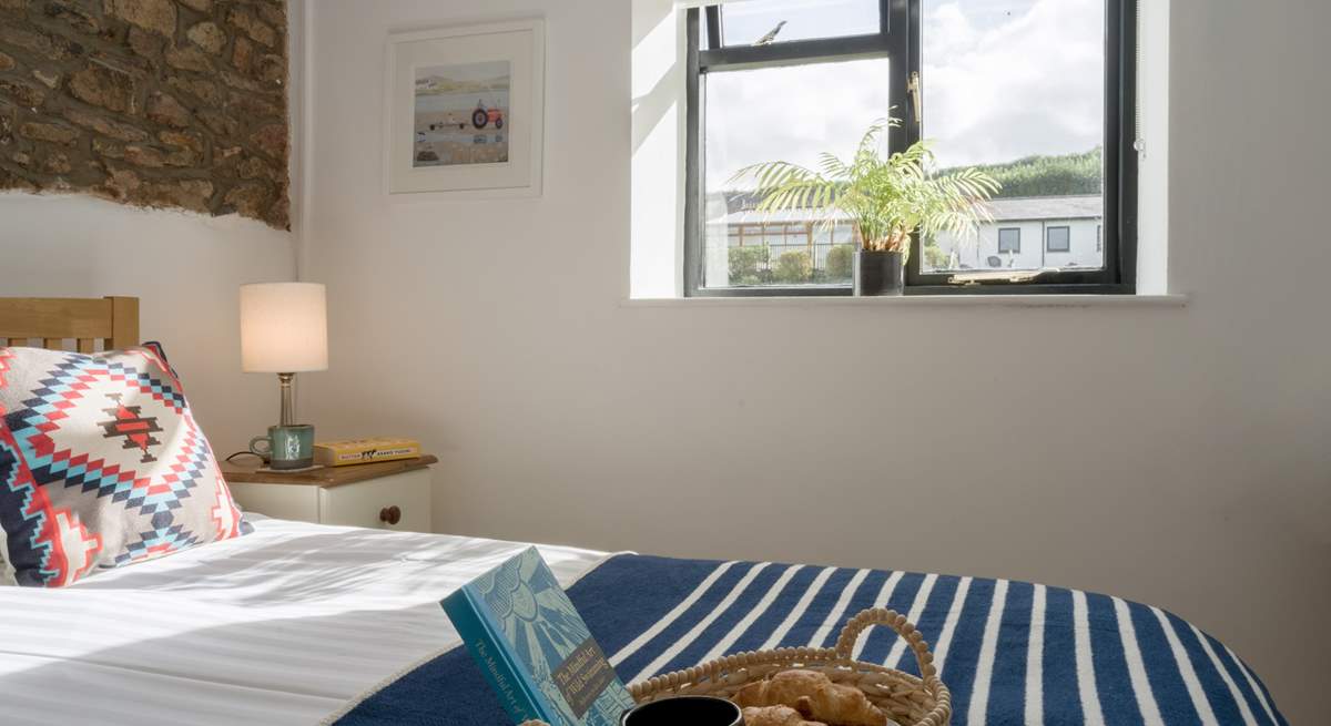 The bedroom looks out over the communal grounds towards the swimming pool.