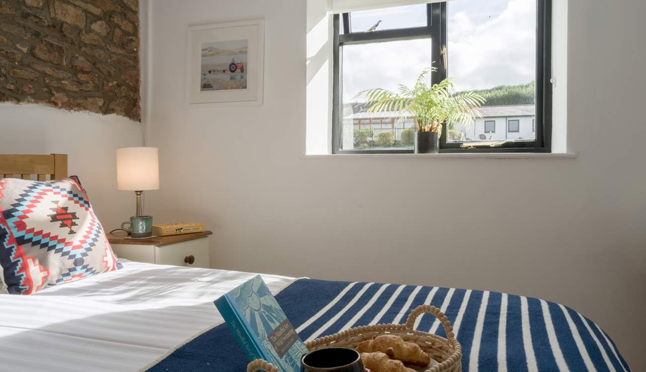 The bedroom looks out over the communal grounds towards the swimming pool.