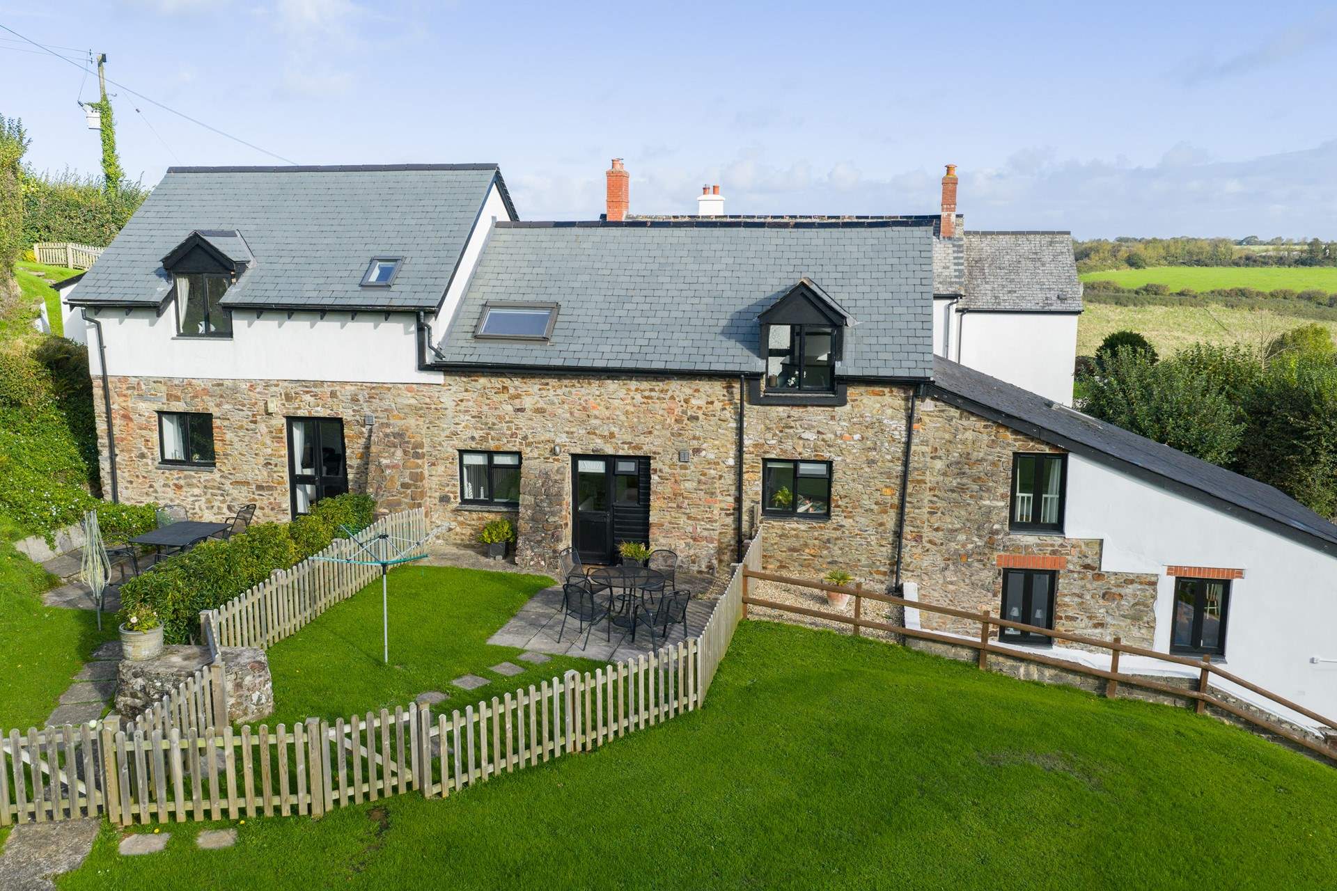 Kingfisher Cottage is the middle property. The garden gate takes you out to the communal grounds and across to the swimming pool and games-room.