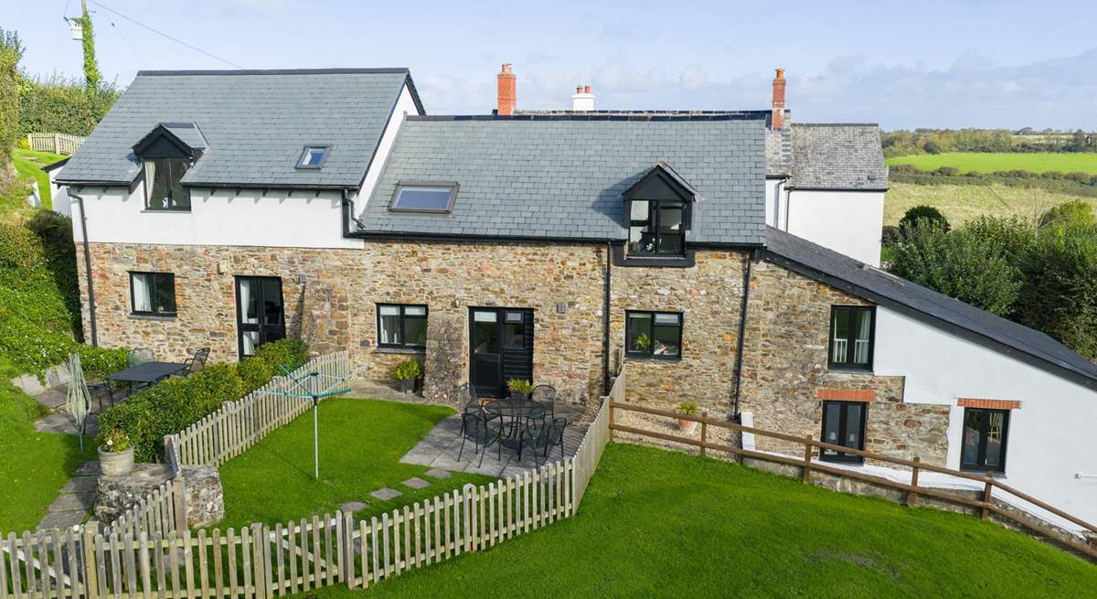 Kingfisher Cottage is the middle property. The garden gate takes you out to the communal grounds and across to the swimming pool and games-room.