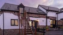 The pretty cobbled courtyard. Kingfisher Cottage is to the right of the stairs.