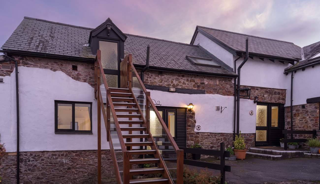 The pretty cobbled courtyard. Kingfisher Cottage is to the right of the stairs.