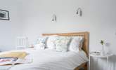The main bedroom on the first floor has a light and airy feel. - Thumbnail Image