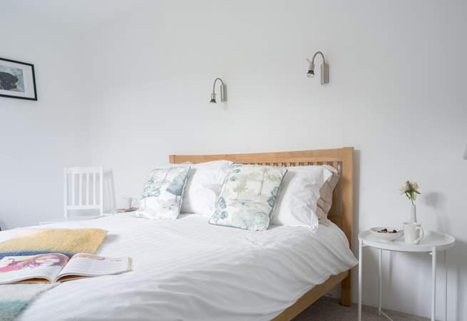 The main bedroom on the first floor has a light and airy feel.