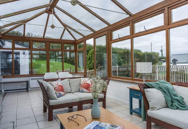 The shared conservatory offers the perfect spot to sit and relax with a good book.