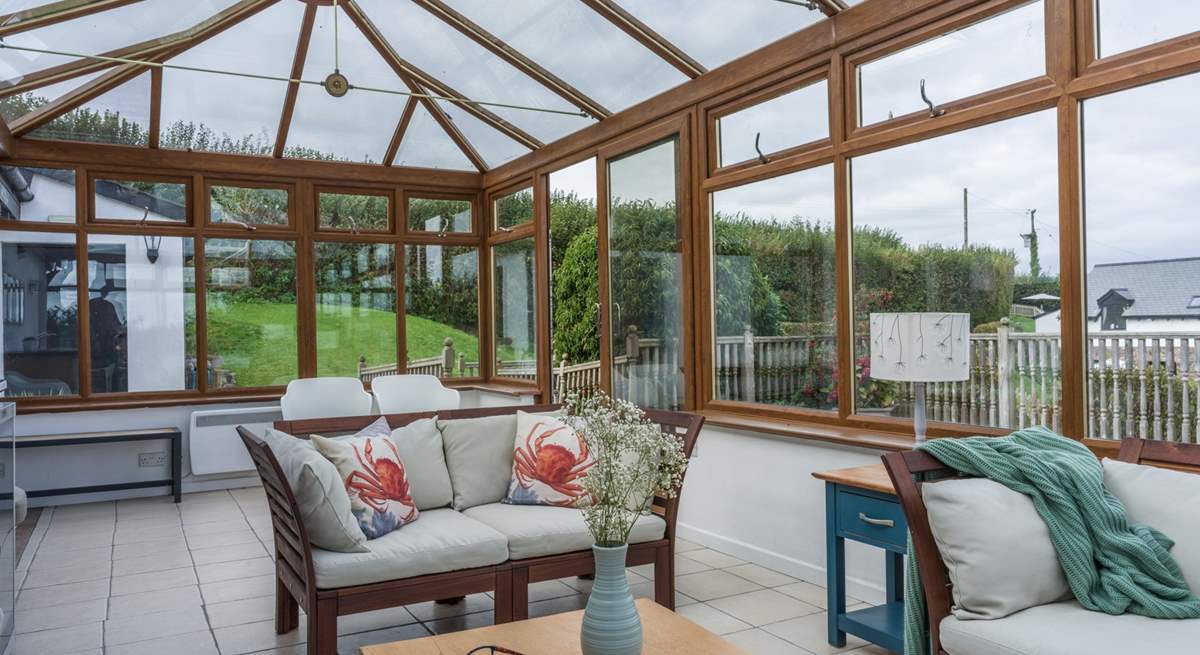 The shared conservatory offers the perfect spot to sit and relax with a good book.