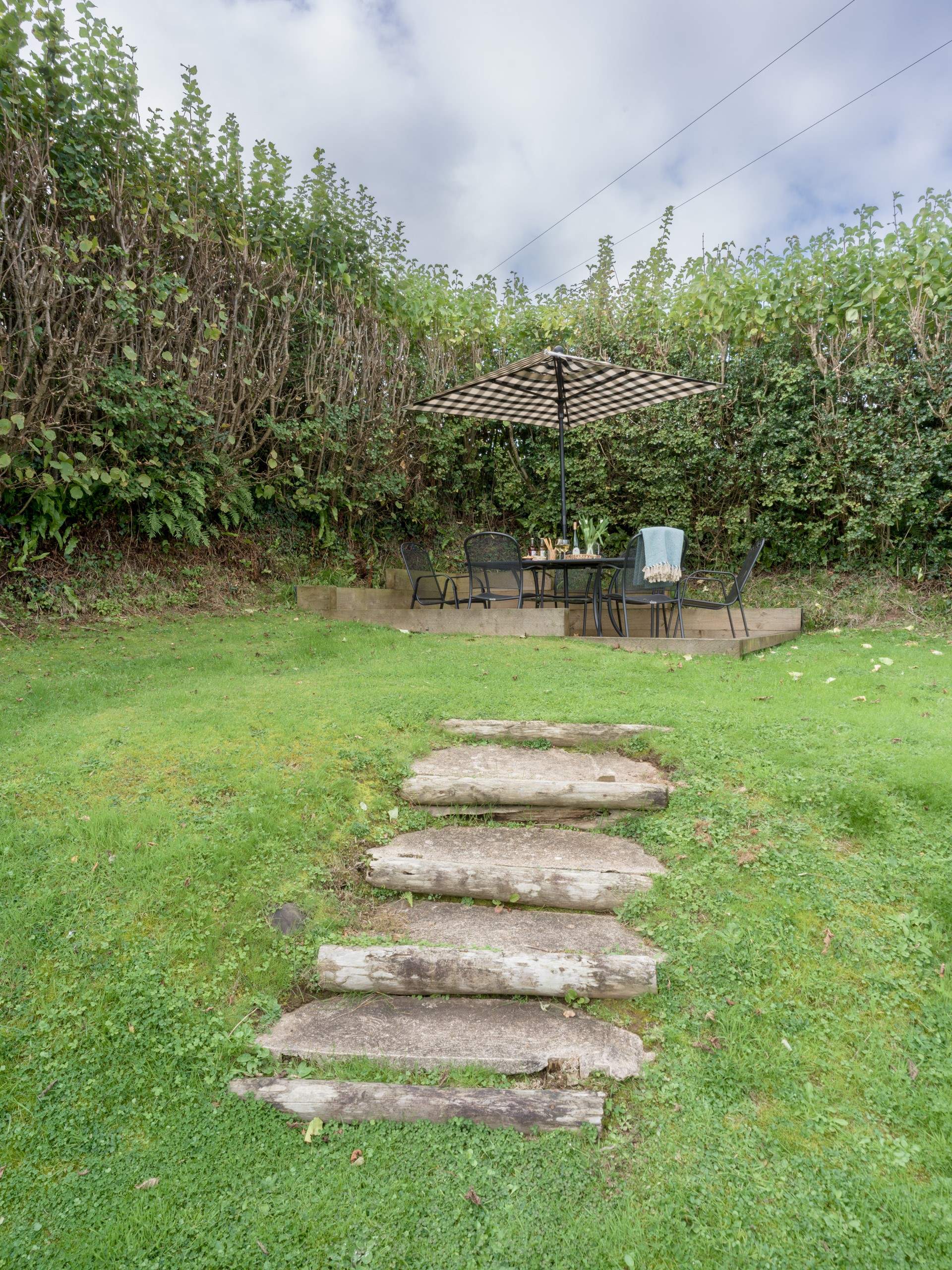 Steps lead up to the patio area at the top of the garden.