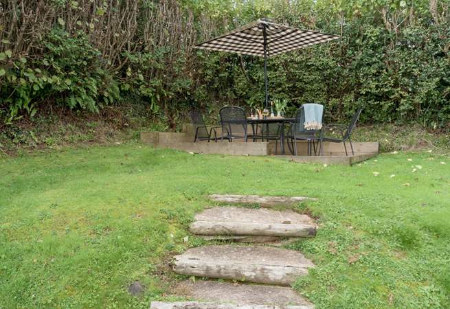 Steps lead up to the patio area at the top of the garden.