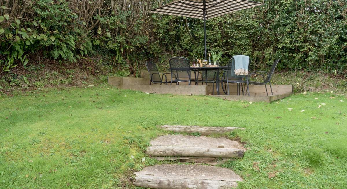 Steps lead up to the patio area at the top of the garden.
