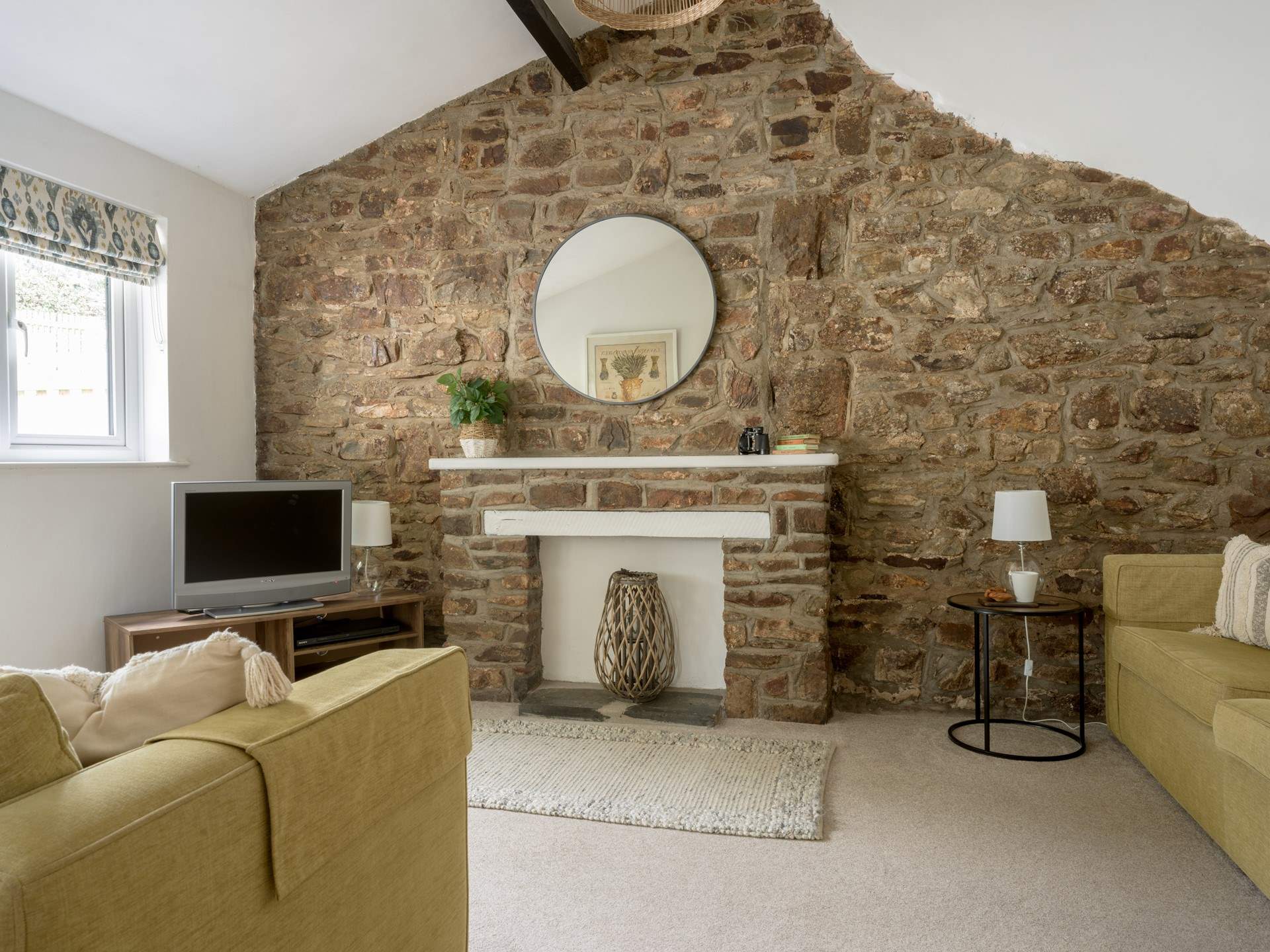 The sitting-room with original stonework and beams.