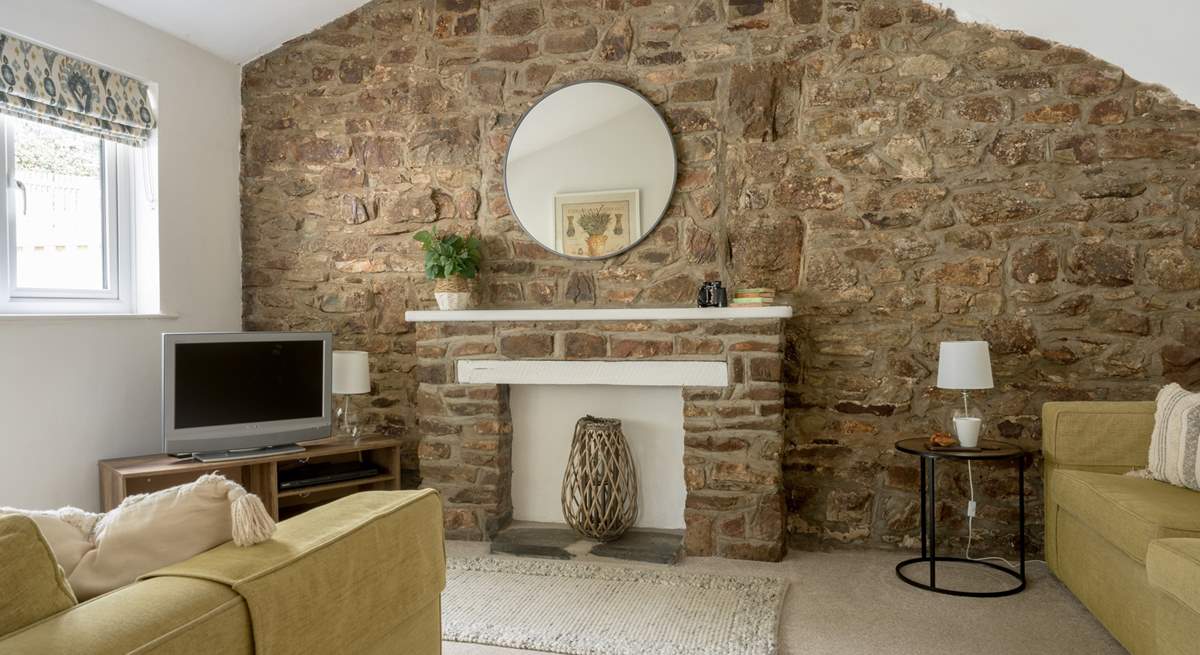 The sitting-room with original stonework and beams.