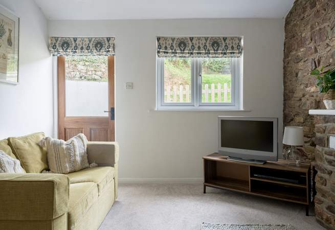 Snuggle down in front of the TV after a day of exploring. The door leads out to your garden.