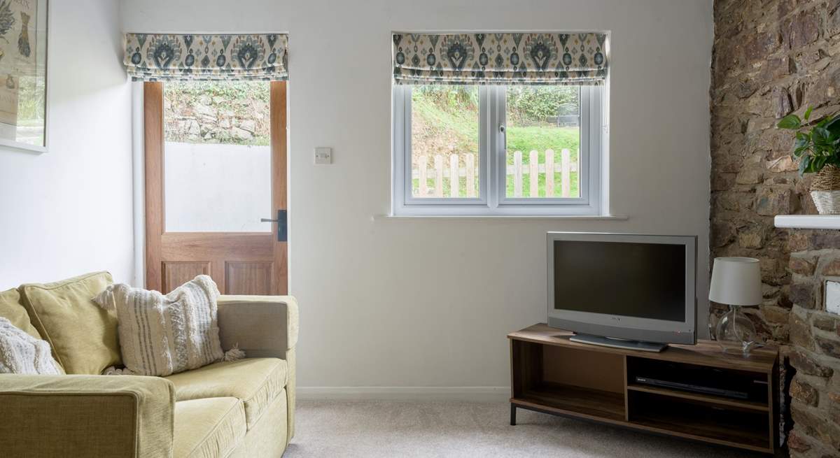 Snuggle down in front of the TV after a day of exploring. The door leads out to your garden.