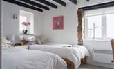 Pretty bedroom 2 is home to these twin beds. - Thumbnail Image