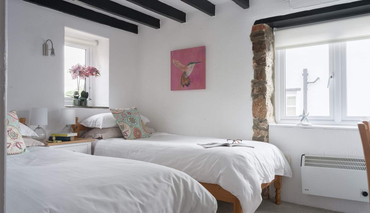 Pretty bedroom 2 is home to these twin beds.