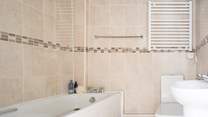 Enjoy a relaxing bath in the family bathroom. There's also a fitted shower for rinsing off those sandy toes.