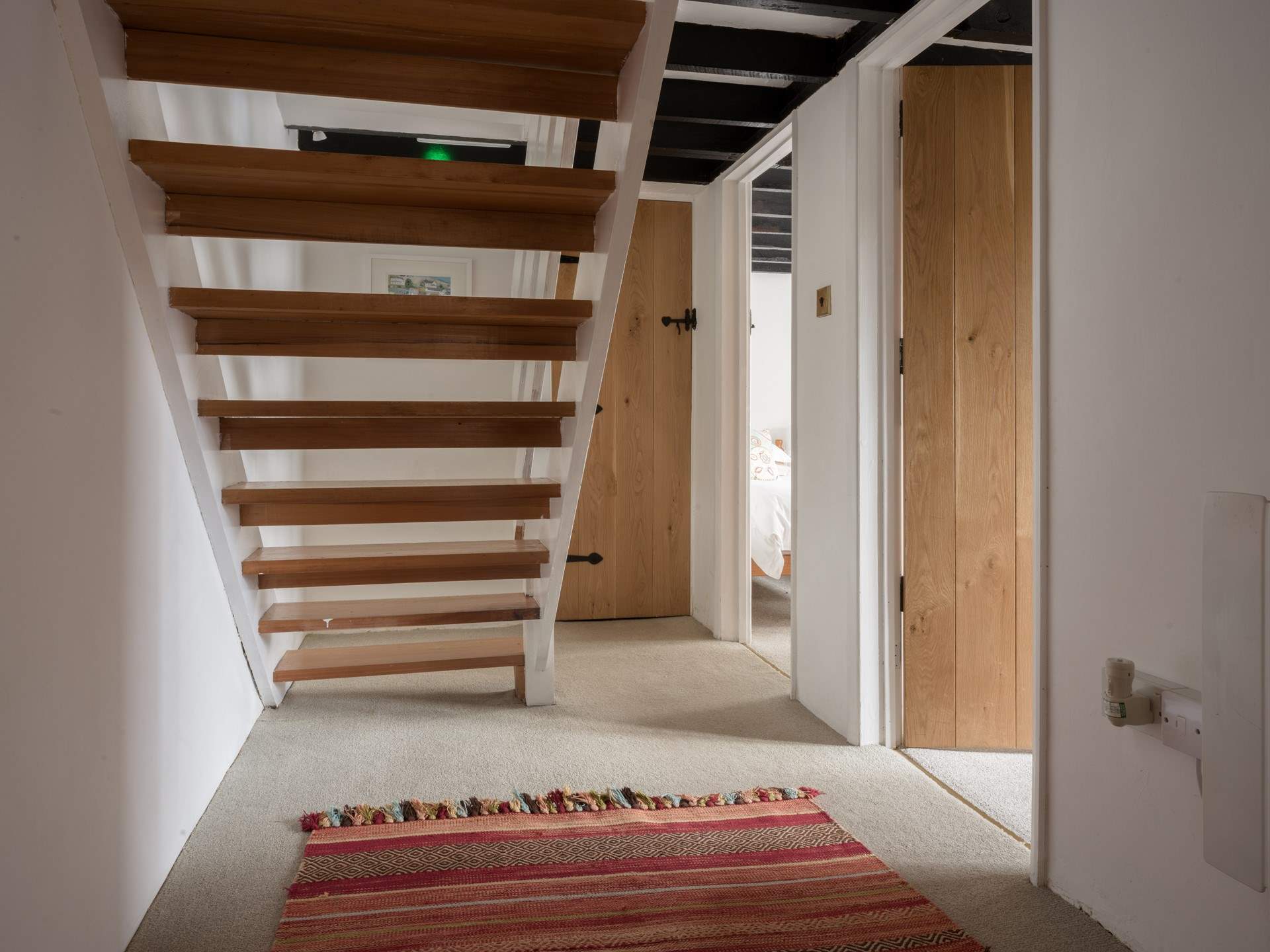 You will find the door to the family bathroom just at the bottom of the stairs.