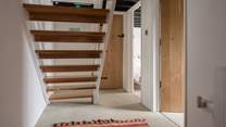 You will find the door to the family bathroom just at the bottom of the stairs.