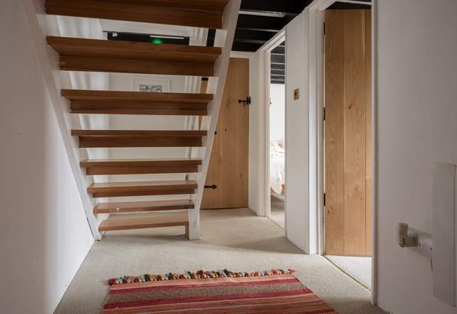 You will find the door to the family bathroom just at the bottom of the stairs.