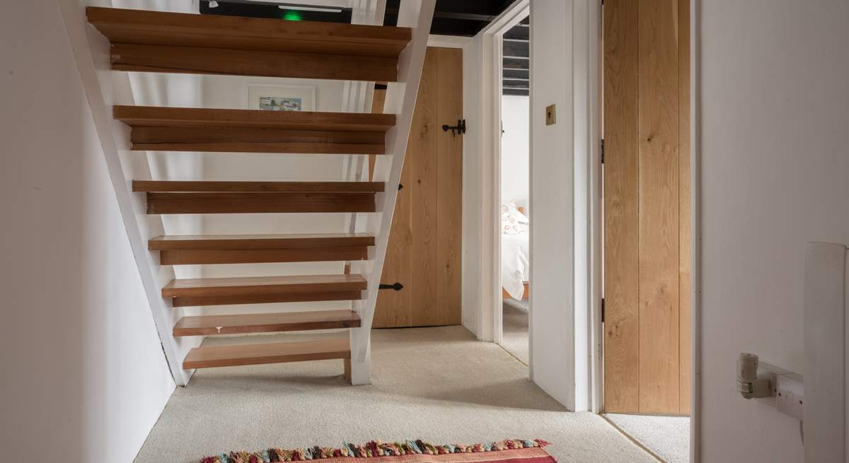 You will find the door to the family bathroom just at the bottom of the stairs.