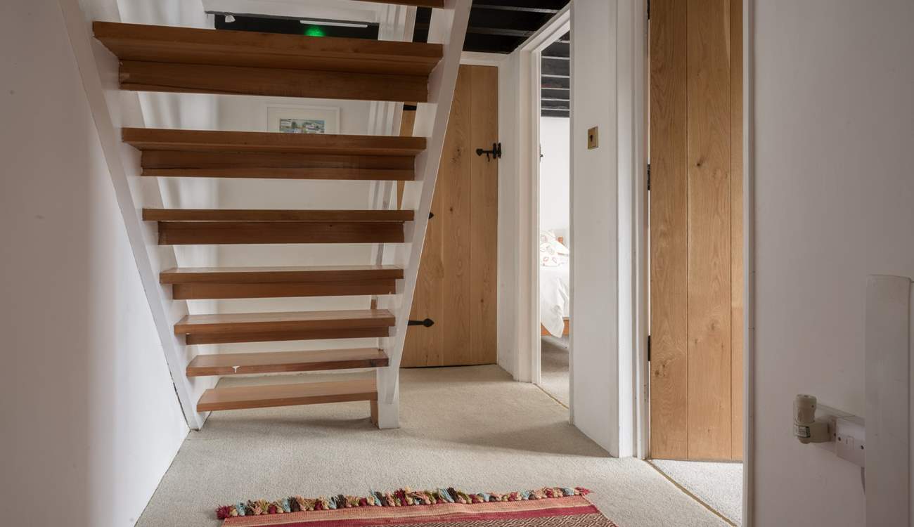 You will find the door to the family bathroom just at the bottom of the stairs.