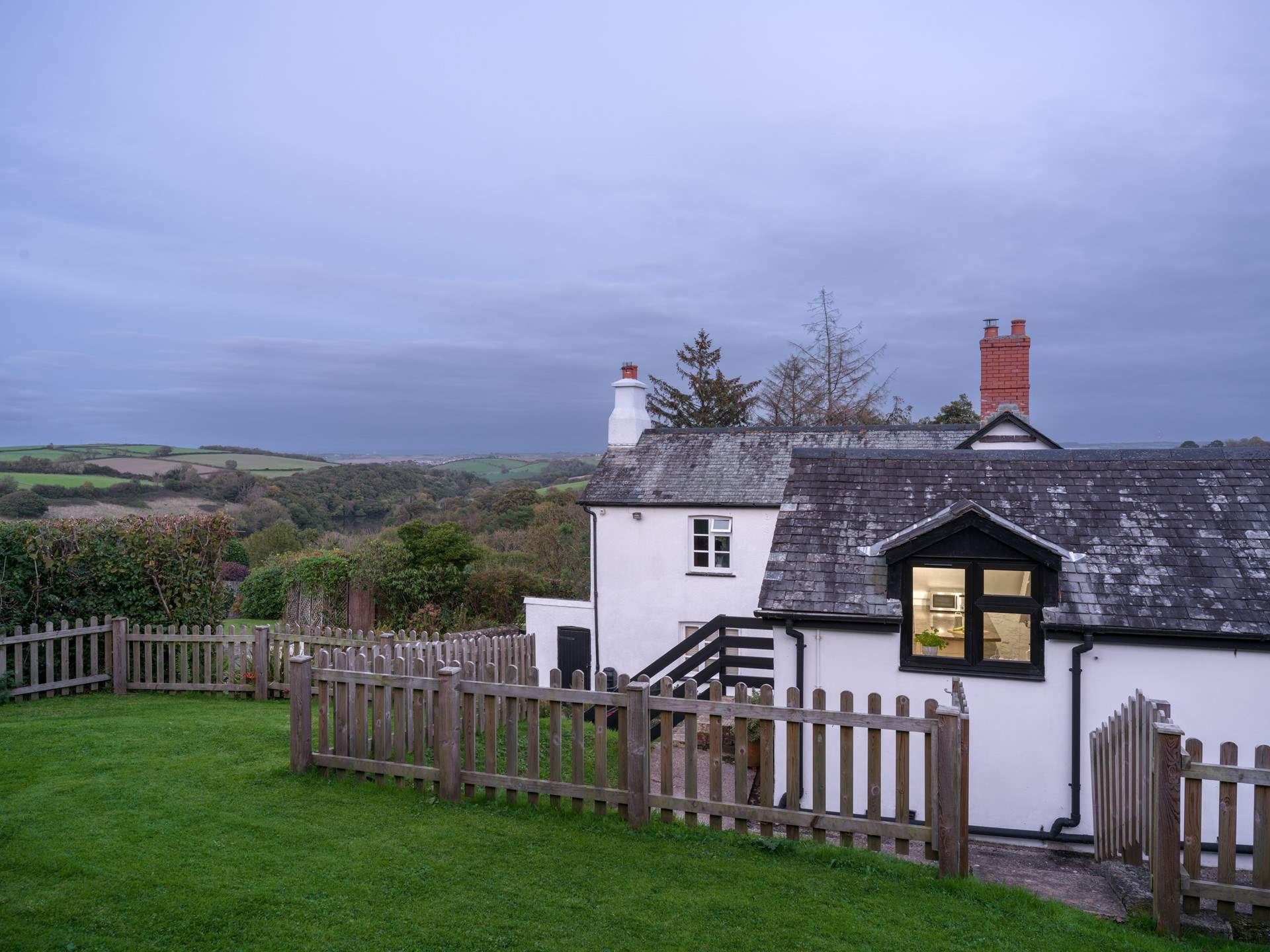 Looking down from the top of the garden through the kitchen window with the owners' home in the background.