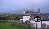 Looking down from the top of the garden through the kitchen window with the owners' home in the background. - Thumbnail Image