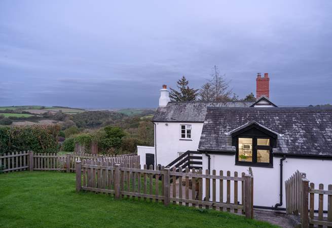 Looking down from the top of the garden through the kitchen window with the owners' home in the background.