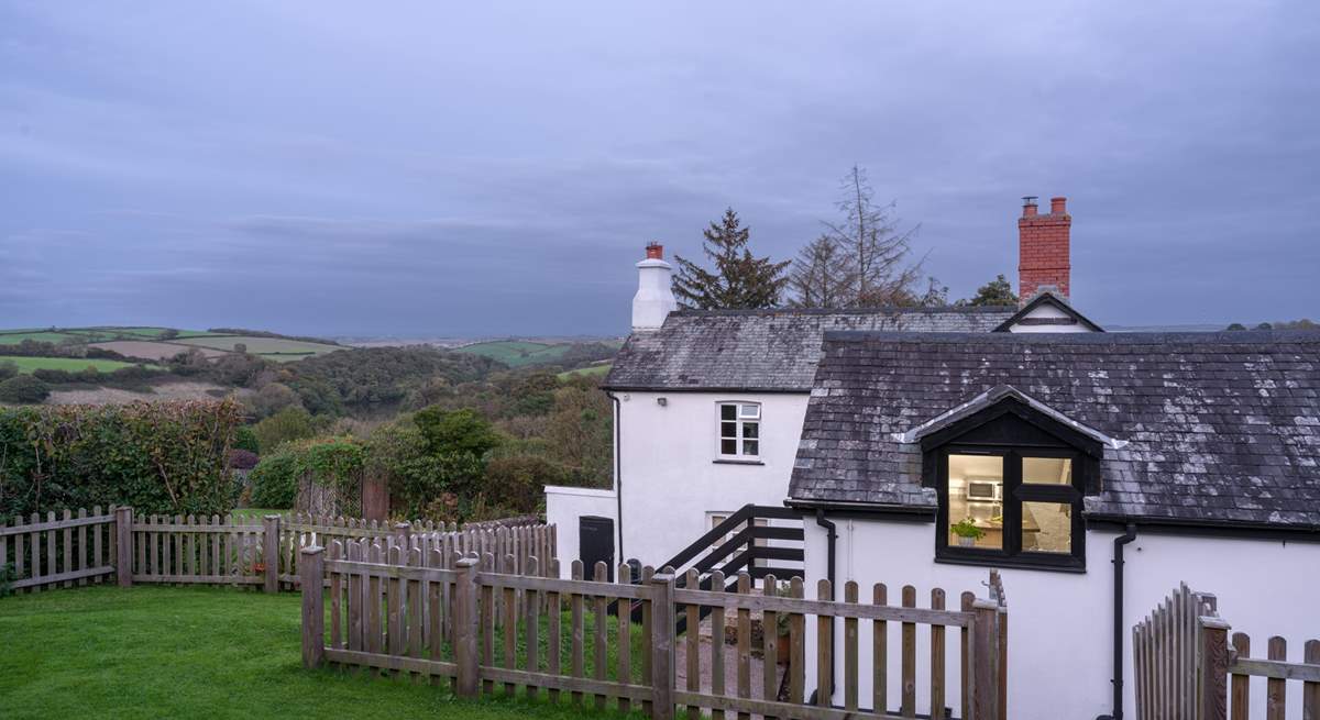 Looking down from the top of the garden through the kitchen window with the owners' home in the background.