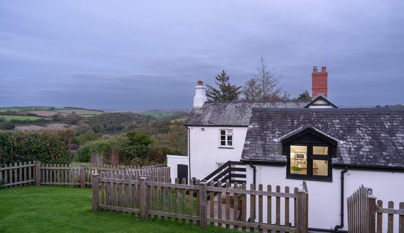 Looking down from the top of the garden through the kitchen window with the owners' home in the background.